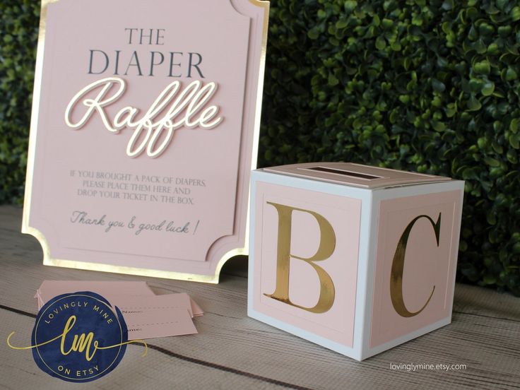 the diaper raffle box is next to it's packaging on a table