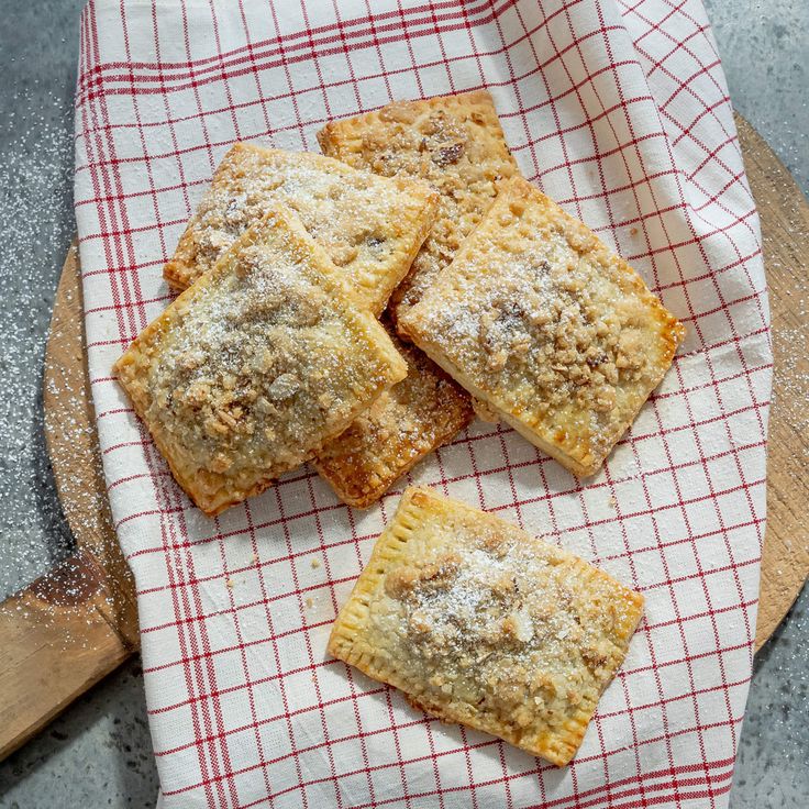 four square pastries on a red and white towel