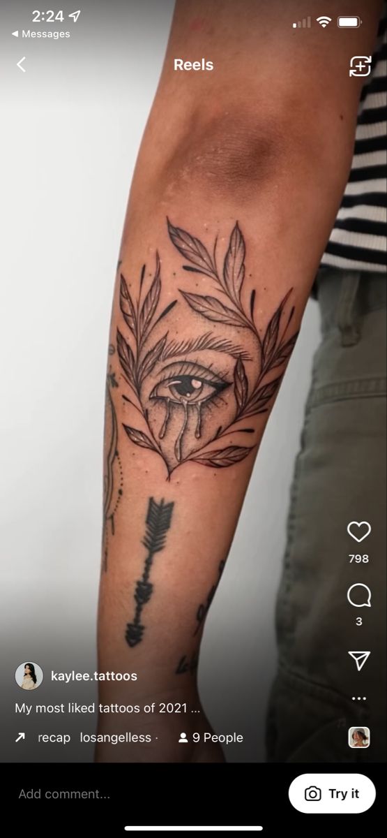 a person with a tattoo on their arm and an arrow in the middle of it