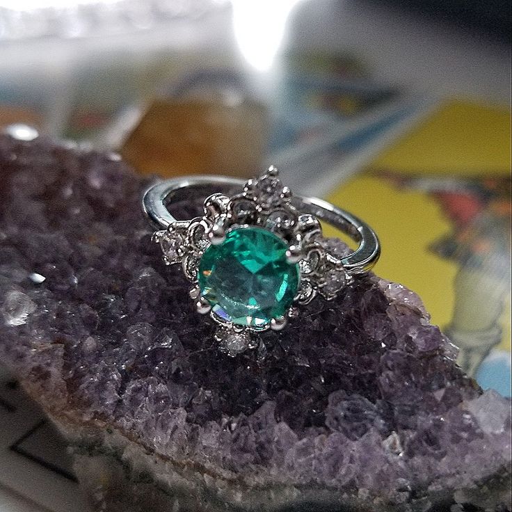 a green ring sitting on top of a rock