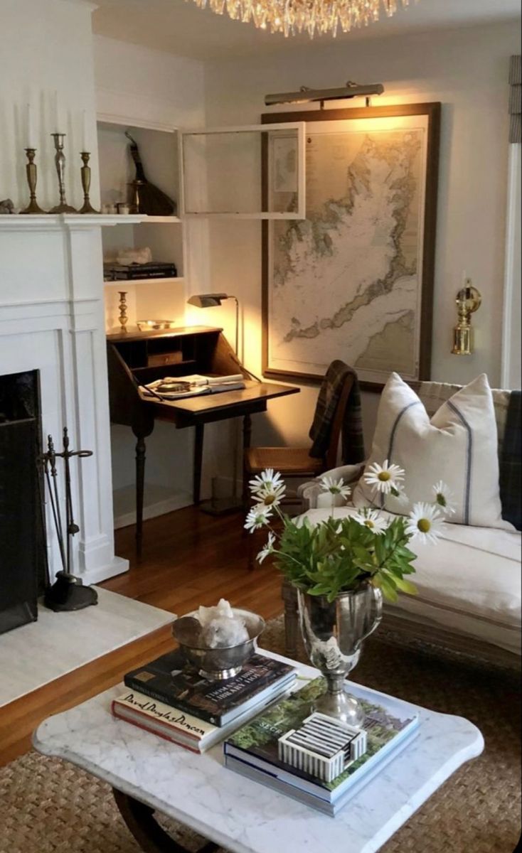 a living room filled with furniture and a fire place in front of a white fireplace