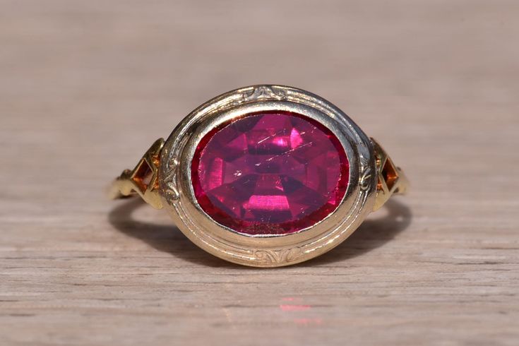 The Dolphin Drive: East to West Antique Filigree Ring. The ring centers on a laboratory grown ruby in the center bezel set East to West. Surrounding the center is a patterned white gold bezel with filigree in yellow gold in the through finger view. The ring would be exceptional by swapping the center and adding a gem or diamond of your choice for an additional charge on request. The ring is crafted in 14 karat white and yellow gold and is currently a finger size 4 3/4 yet can be adjusted to any Antique Filigree, Antique Wedding Rings, Wedding Rings Vintage, Filigree Ring, Ruby Ring, Bezel Setting, Rings Statement, Statement Rings, Jewelry Watches