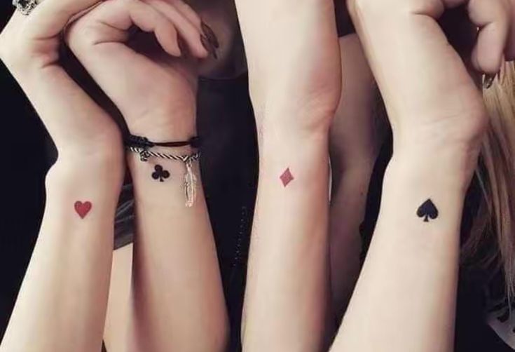 four girls with matching tattoos on their arms