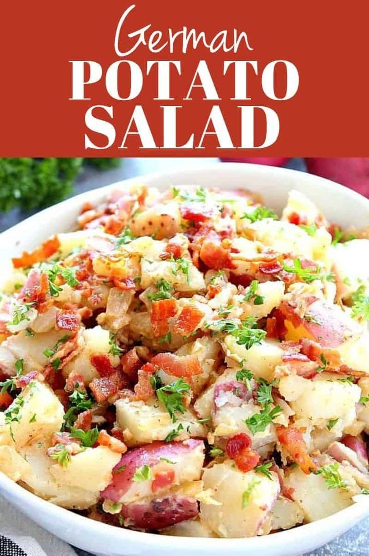 german potato salad with bacon and parsley in a white bowl on top of a table