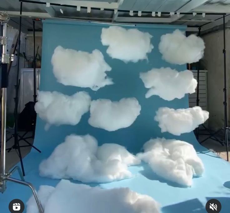 there is a blue backdrop with white clouds on it