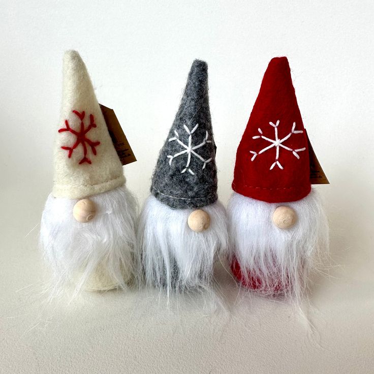 three gnomes with snowflakes on their hats