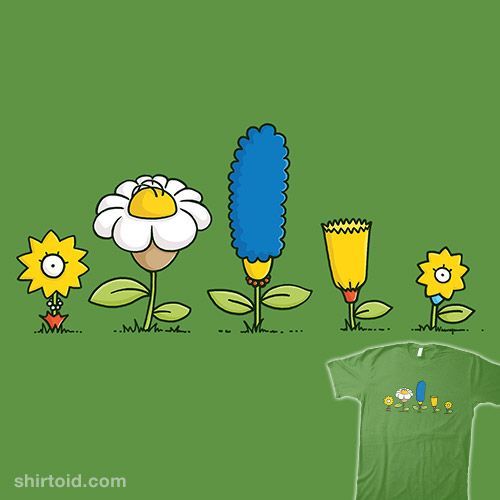 a t - shirt with cartoon characters on it and flowers in the grass next to each other