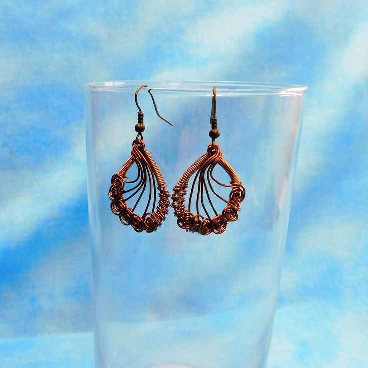 Non tarnish antique copper wire is meticulously hand woven and sculpted into oval shaped earrings on fish hook ear wires. These interesting and artistic earrings are one of a kind. The design lends itself to many styles and colors of clothing and will be a classic for years to come. The earrings measure 1 1/4 inches long by 1 inch wide. Your unique earrings are ready to ship via USPS to your US location at no extra cost. (International shipping available. Please be aware of your local laws relat Handmade Bohemian Wire Earrings, Bronze Wire Wrapped Earrings, Elegant Brown Copper Wire Jewelry, Unique Handmade Copper Wrap Earrings, Bohemian Oval Wire Wrapped Earrings, Artisan Wire Wrapped Copper Earrings, Handmade Brown Copper Wire Earrings, Bronze Teardrop Jewelry In Copper Wire, Bohemian Hand Wrapped Copper Wire Earrings