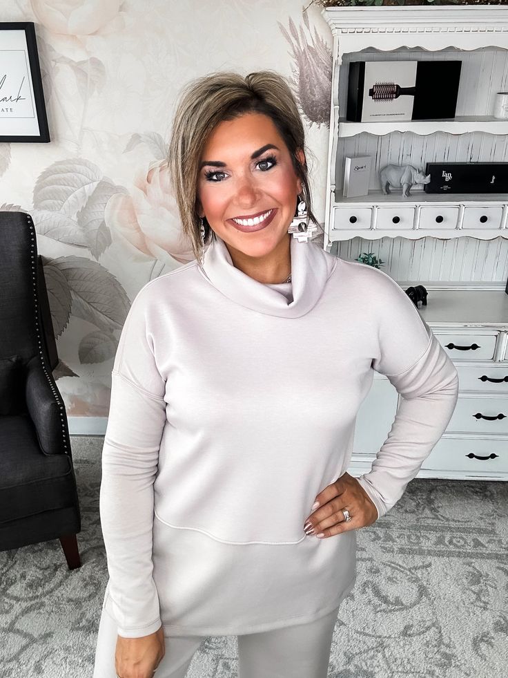 Slip into this cozy cowlneck top and you'll instantly be wrapped in softness. Lovingly crafted from a modal feel blend, this tunic feels like your favorite well-worn sweatshirt but looks polished enough for a night out. With a relaxed, flowy fit, side slits and long sleeves to keep you cozy, this top moves with you from couch to cocktails. The dramatic cowl neckline adds stylish drape and an alluring touch, perfect for showing off a statement necklace. Whether you're winding down on the weekend Casual Cowl Neck Loungewear Top, Funnel Neck Top For Loungewear, Funnel Neck Soft Knit Tops For Layering, Relaxed Fit Soft Knit Funnel Neck Top, Chic Cozy Fit Tops For Loungewear, Chic Cowl Neck Top, High Neck Soft Knit Top For Layering, Chic High Neck Loungewear Top, Turtleneck Sweatshirt For Loungewear