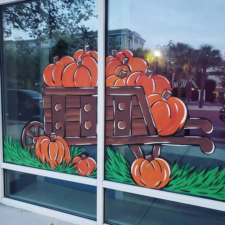 a window with pumpkins painted on it