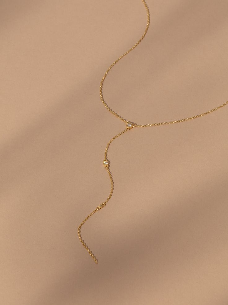 Want the perfect layering necklace? Our Shiner Lariat Vermeil Necklace is the one. Crafted with 18k gold over sterling silver and real, slightly included round-cut diamonds, this Y-shaped necklace brings a shiny, luxurious touch to your look. Pair this dainty chain necklace with your other favorite gold Vermeil jewelry styles for a look that’s glamorous and effortless. Fine Jewelry Yellow Gold Backdrop Necklace With Delicate Chain, Yellow Gold Adjustable Backdrop Necklace, Yellow Gold Backdrop Necklace With Adjustable Chain, Dainty Adjustable Yellow Gold Lariat Necklace, Elegant Lariat Necklace, Tarnish Resistant, Elegant Tarnish Resistant Lariat Necklaces, Elegant Tarnish Resistant Lariat Necklace, Adjustable Yellow Gold Backdrop Necklace With Delicate Chain, Dainty Yellow Gold Backdrop Necklace With Clavicle Chain