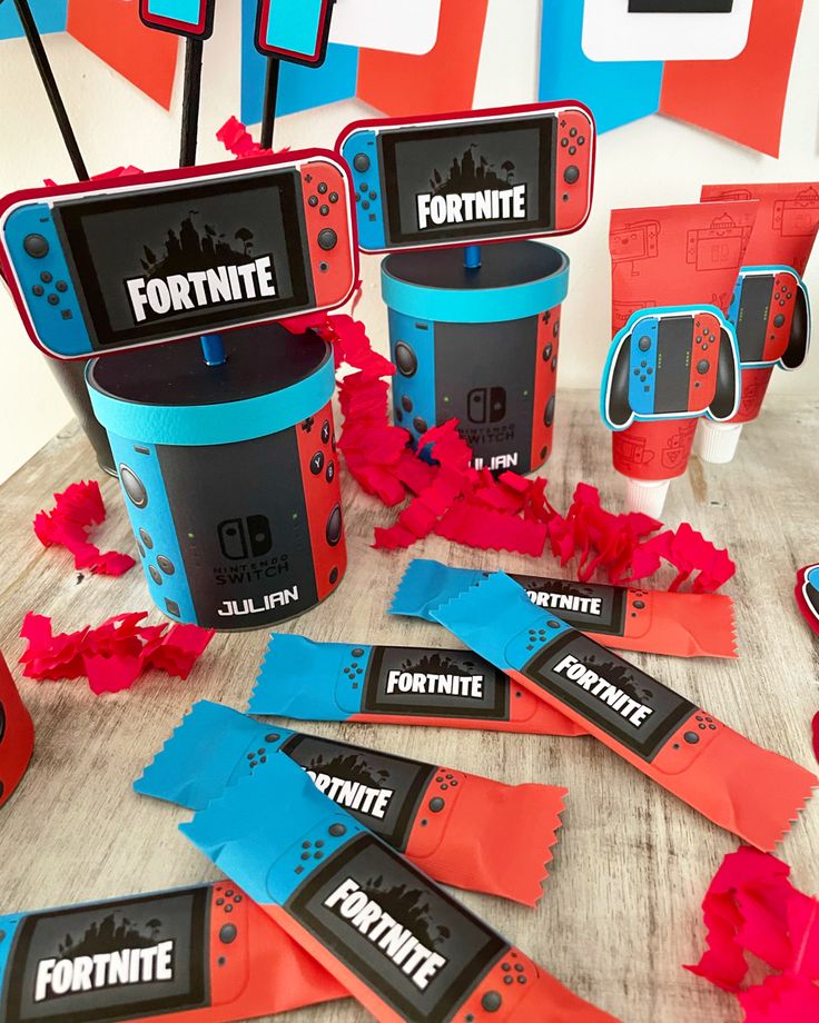 the nintendo wii game console is surrounded by red and blue paper streamers that spell out fortnite