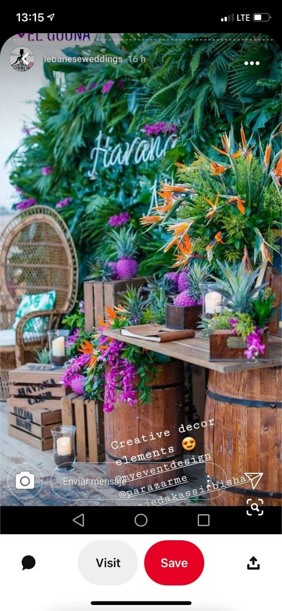 an outdoor bar decorated with flowers and plants