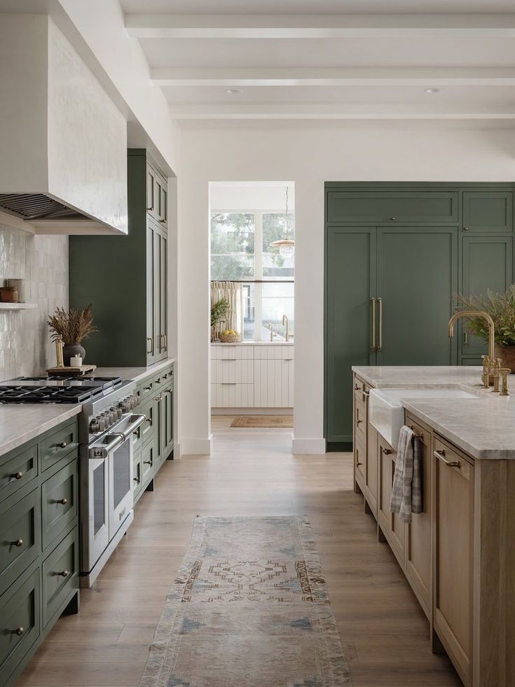 the kitchen is clean and ready for us to use it's green cabinetry