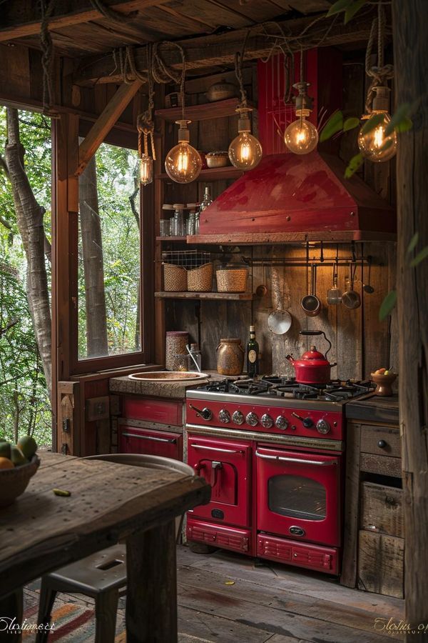 a red stove top oven sitting inside of a kitchen next to a table and chairs