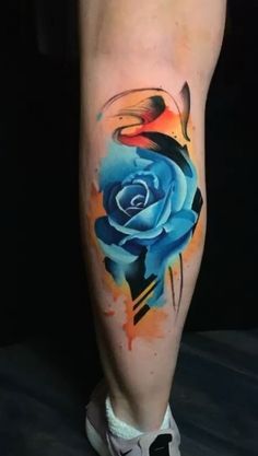 a person with a blue rose tattoo on their leg and foot, painted in watercolors