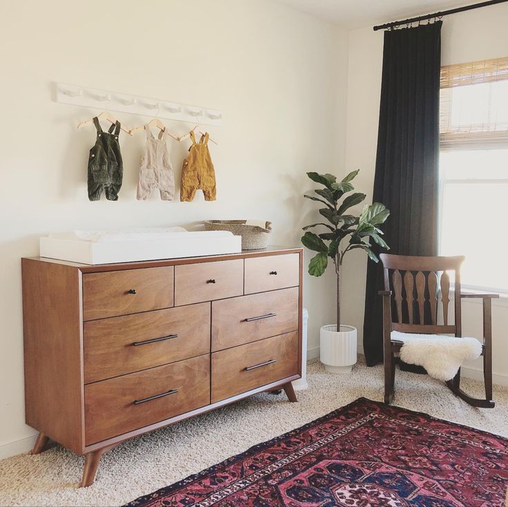 a baby crib in the corner of a room with a rug on the floor