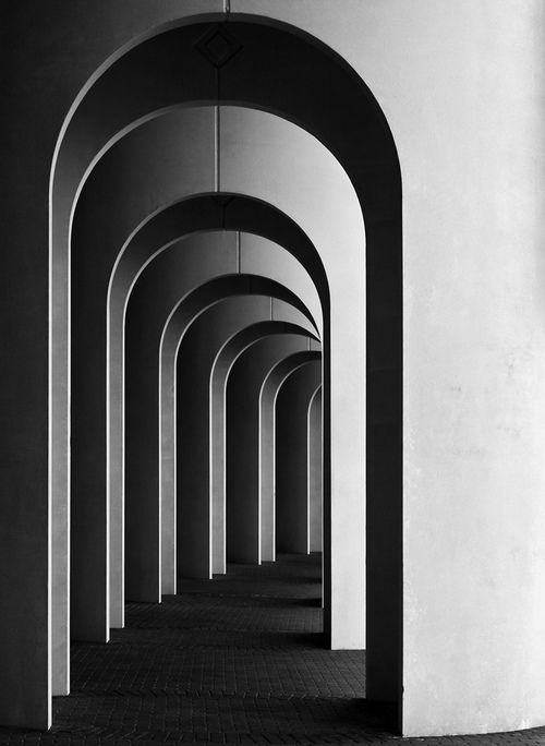 black and white photograph of an arch lined with arches