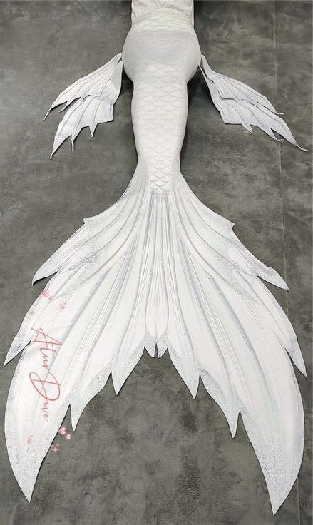 a white mermaid costume on the ground