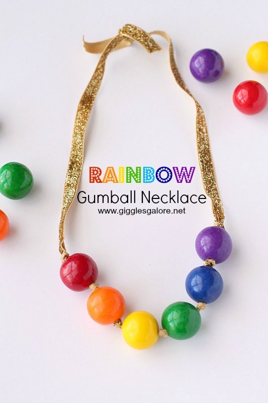 the necklace is made out of gummy balls and has a gold ribbon around it