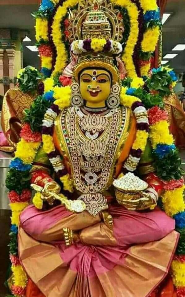 the statue is decorated with flowers and garlands