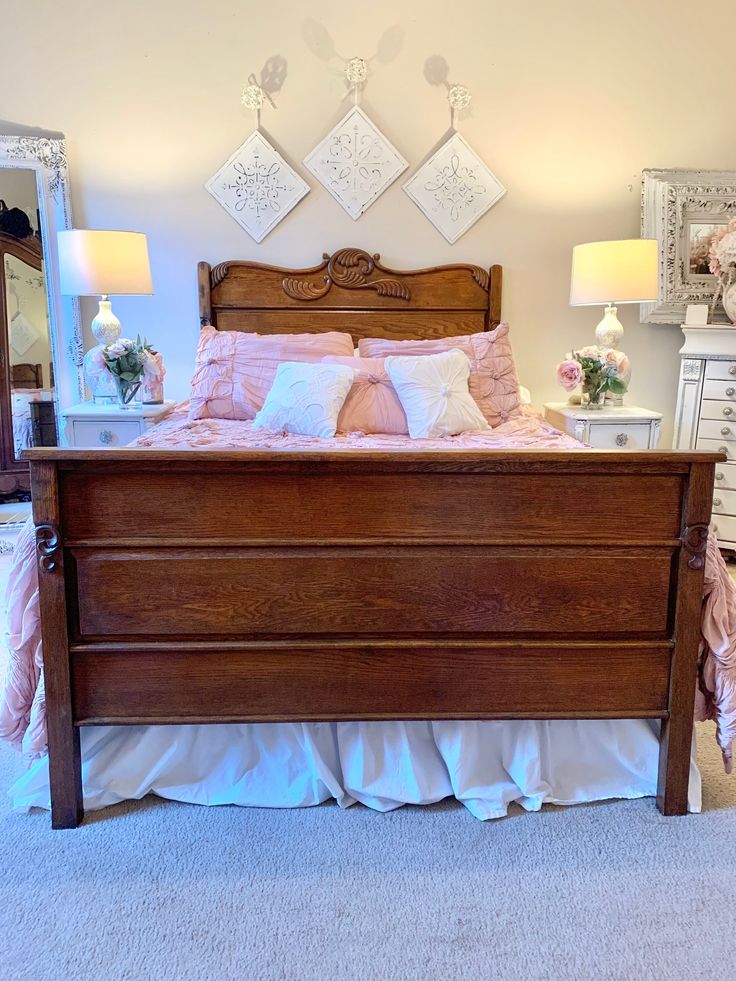 a large bed sitting in the middle of a bedroom next to a dresser and mirror