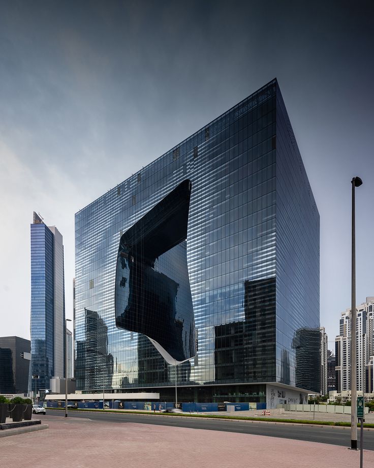 a large glass building in the middle of a city