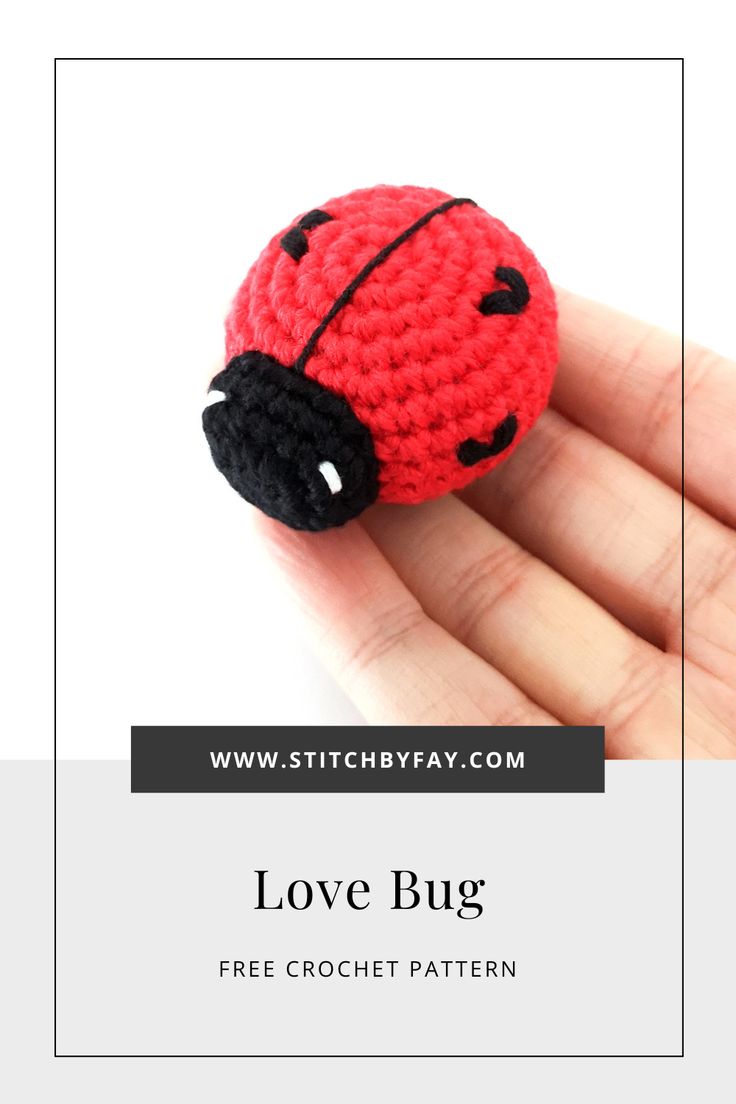 a small crocheted ladybug sitting on top of a hand