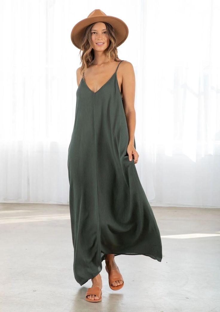 Dark Green Colored Tank Top style Maxi Dress. With pockets attached V-neck Maxi Sundress For Day Out, Unlined V-neck Maxi Dress For Beach, Casual V-neck Maxi Dress For Date Night, Chic Summer Maxi V-neck Dress, Spring V-neck Maxi Dress For Date Night, Chic V-neck Rayon Maxi Dress, Spring Floor-length Sleeveless Beach Dress, Floor-length Sleeveless Dress For Beach Spring, Flowy Maxi V-neck Dress For Summer