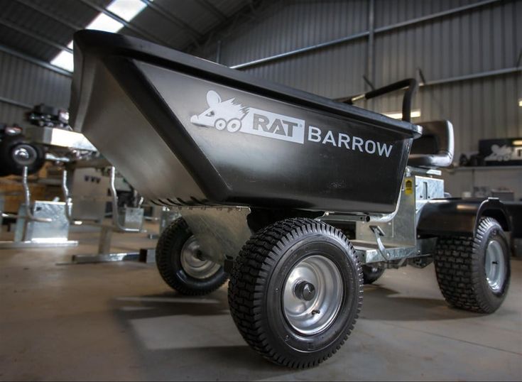 a small boat is parked in a building with wheels on the front and back sides