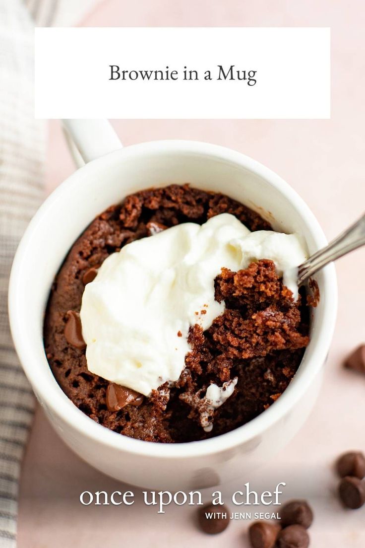 brownie in a mug with whipped cream and chocolate chips