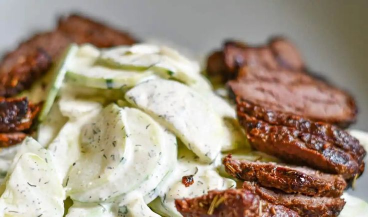 a white plate topped with meat and dressing