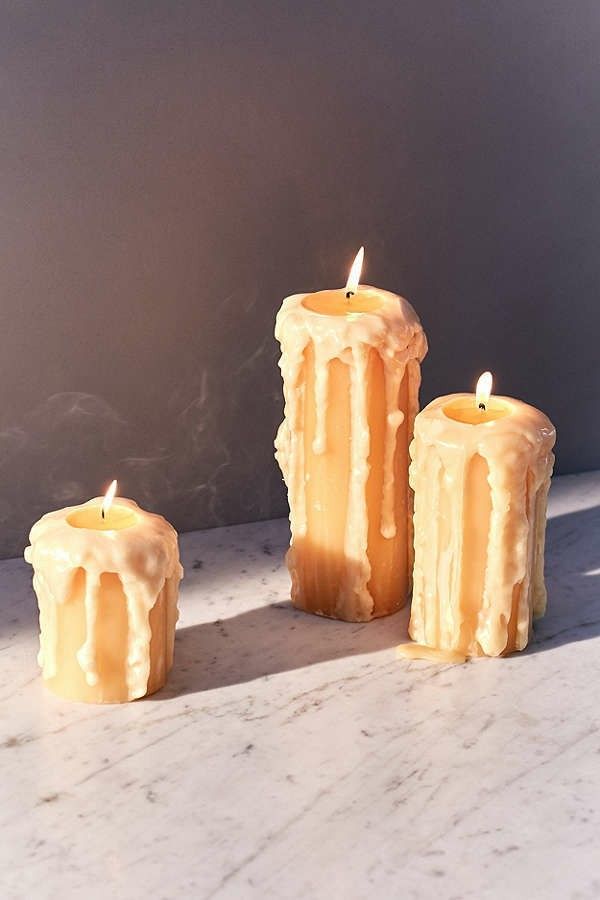 three candles sitting on top of a table