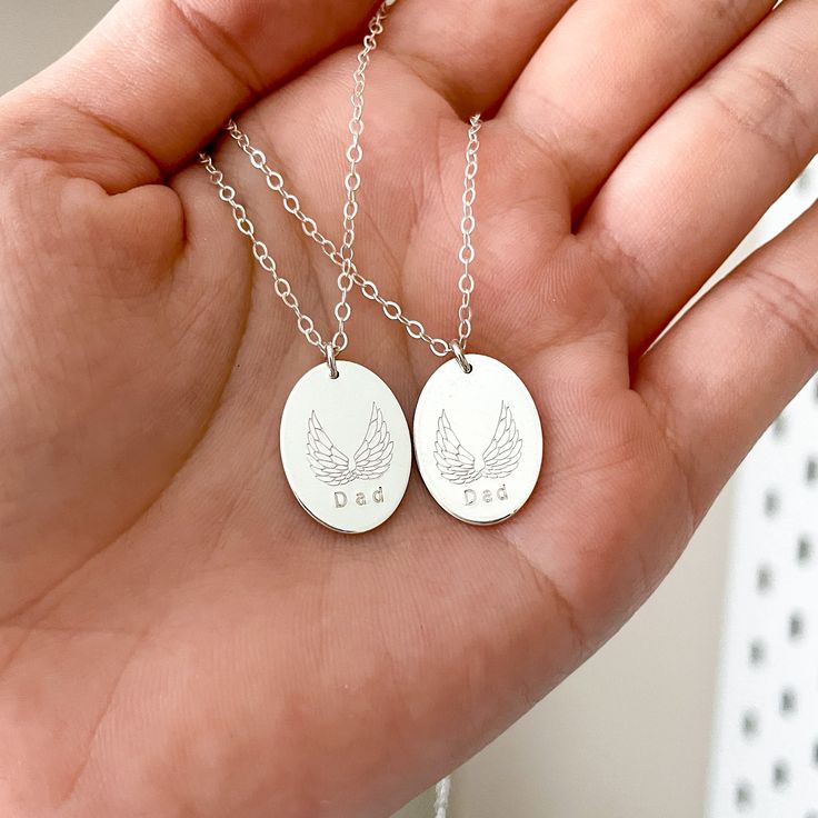 Our angel wings necklace is a treasured everyday keepsake that you can wear close to your heart to commemorate a loved one until you meet again - and the details in each majestic wing is absolutely stunning. Oval pendant measures 18mm x 13mm Personalise it with a short name (up to 5 characters max) or an initial Hand stamped with our 1.5mm tiny block font Pendant can only be hand stamped on one side Made entirely from precious metals - Sterling silver / Gold filled - and designed to last Each St Engraved Oval Pendant Charm Necklace For Anniversary, Personalized Oval Pendant Necklace For Anniversary, Personalized Anniversary Necklace With Oval Pendant, Sterling Silver Oval Necklace For Mom, Oval Sterling Silver Necklace For Mom, Nickel Free Oval Pendant Jewelry For Memorial, Oval Silver Necklace For Personalized Gift, Nickel Free Oval Pendant Jewelry For Memorials, Sterling Silver Oval Pendant Necklace For Personalized Gift