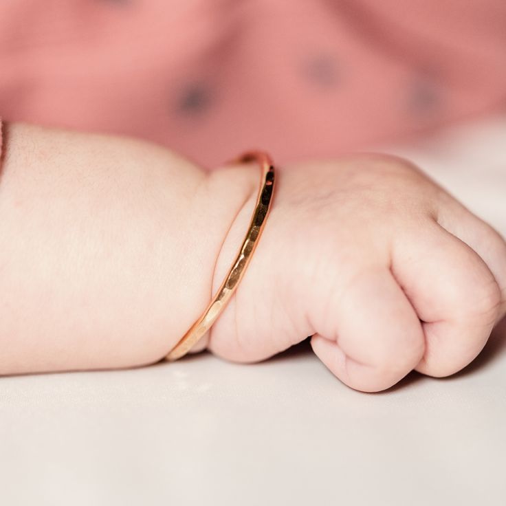 "Looking for a unique baby shower gift? Give your little ball of sunshine the cutest jewelry for every day. This will match her every outfit! M A T E R I A L Sterling Silver 14k Yellow Gold Filled 14k Rose Gold Filled S I Z E S Right out the womb 4 in Newborn hand circumference: 4 1/2 in Crawler hand circumference: 5 in Walker hand circumference: 5 1/2 in D E T A I L S Made of 12 gauge wire Packaged with a mesh pouch, perfect for gift giving. H O W ⋯ T O ⋯ S I Z E Step 1: Close your hand so that Rose Gold 14k Gold Keepsake Jewelry, Personalized Rose Gold Bracelet For Everyday Wear, Personalized Rose Gold Bracelet For Everyday, Delicate Stackable Bangle As Gift, Pink Gold Bracelet Gift, Stackable 14k Gold Name Bracelet, 14k Gold Stackable Name Bracelet Gift, Hypoallergenic Rose Gold Bracelet, Adjustable 14k Gold Bracelet For Birthdays