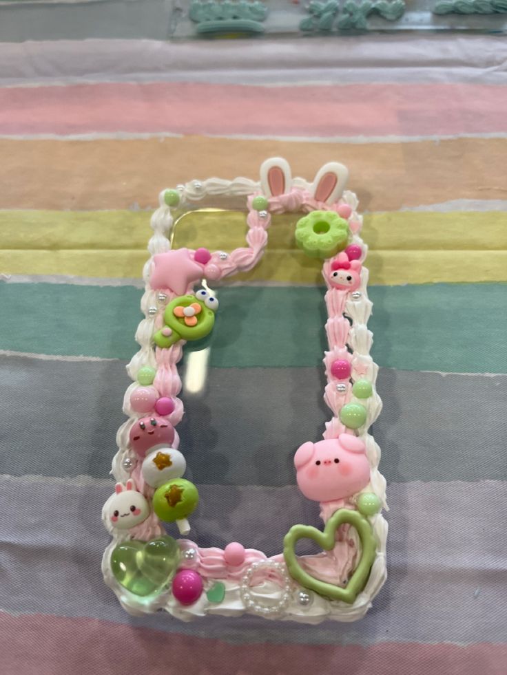 the letter e is made out of plastic beads and stuffed animals on it's sides