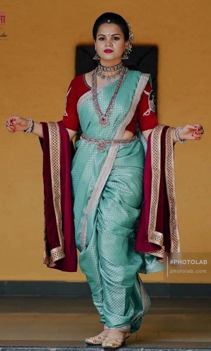 a woman in a green and red sari