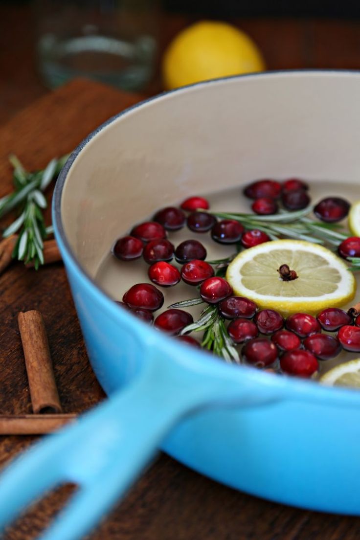 a pan filled with lemons and cranberries on top of a wooden table