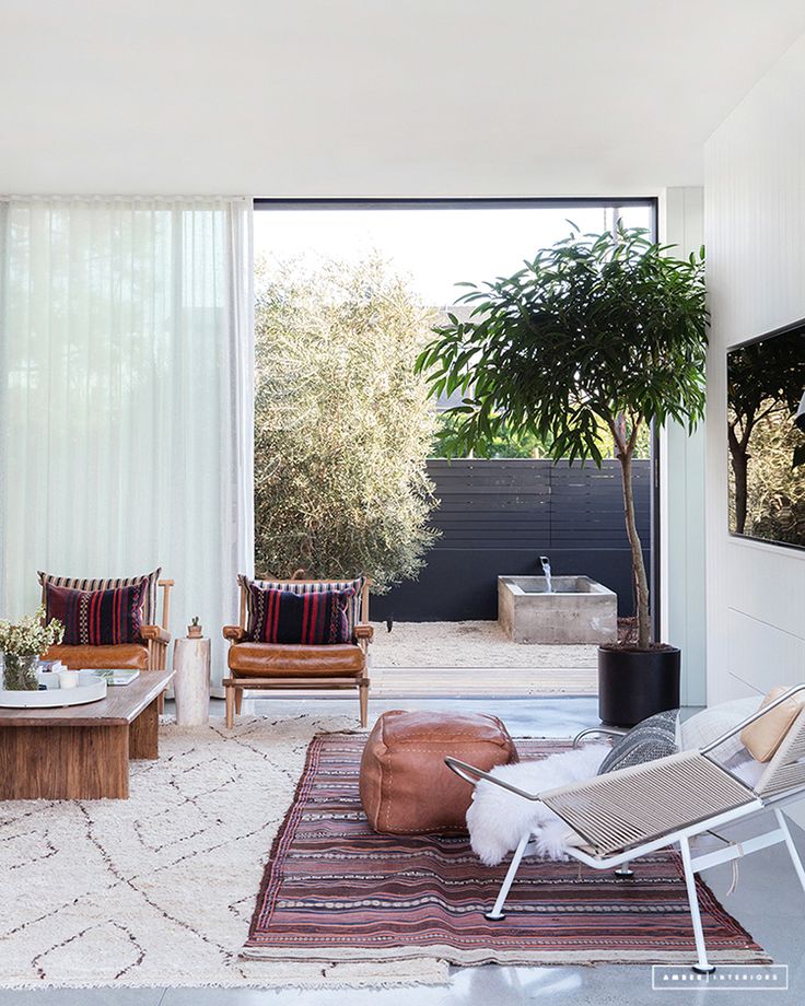 a living room filled with furniture and a tree