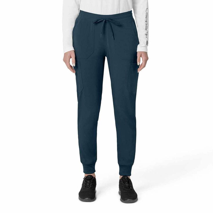 The Carhartt Women's Cargo Jogger Scrub Pant – your dependable partner for demanding days in the medical field. Crafted from a durable and comfortable polyester spandex blend, these pants offer the flexibility you need to handle any task with ease. Whether you're pushing carts, adjusting equipment, or attending to patients, the built-in flex ensures you move freely and comfortably. The rib-knit comfort waistband with elastic and a full drawstring ensures a secure, no-pinch fit that won't dig in Carhartt Utility Leggings, Carhartt Womens Scrubs, Non-stretch Workwear Bottoms With Pockets, Carhartt Style, Outdoor Cargo Pants With 4-way Stretch, 4-way Stretch Cargo Pants With Functional Pockets For Outdoor, Carhartt Womens, Medical Uniforms, Cargo Joggers