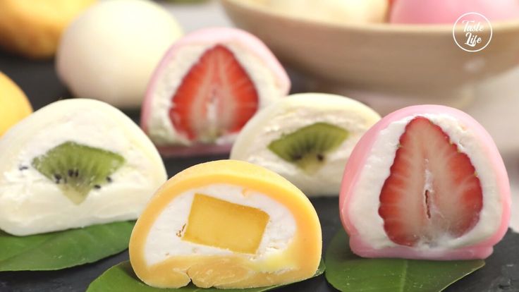 some fruit is cut in half and placed on top of each other with green leaves