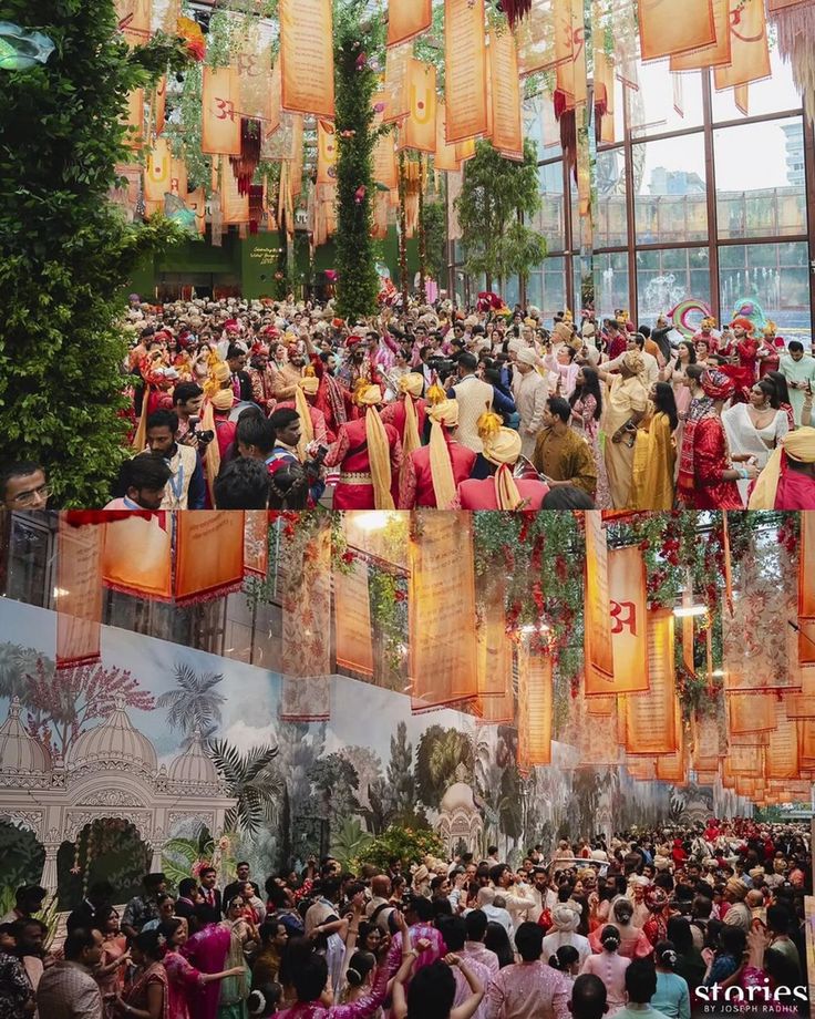 a large group of people standing in front of a building with lanterns hanging from the ceiling