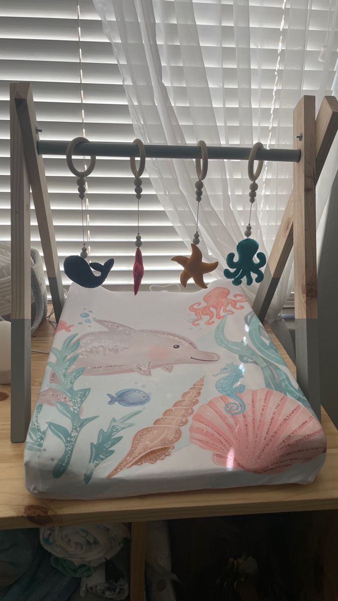 a child's bed with an ocean theme on it