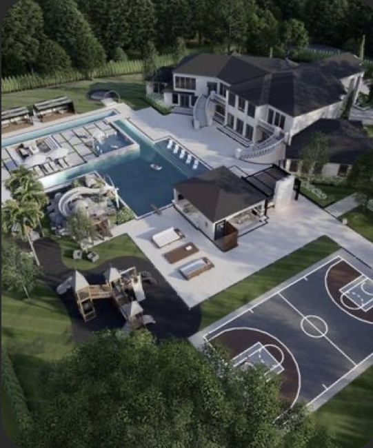 an aerial view of a large house with a basketball court in the middle of it