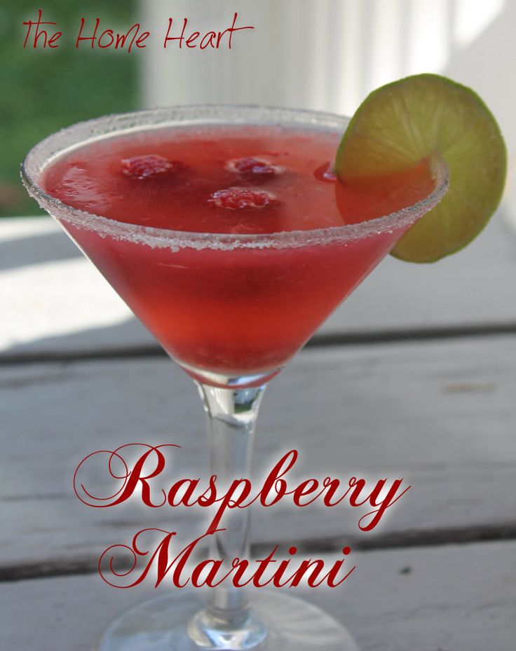 raspberry martini with lime garnish on the rim