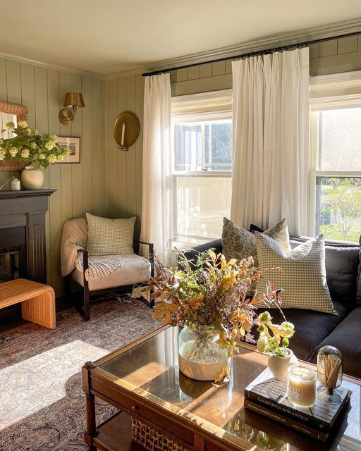 a living room filled with furniture and a fire place in front of a large window