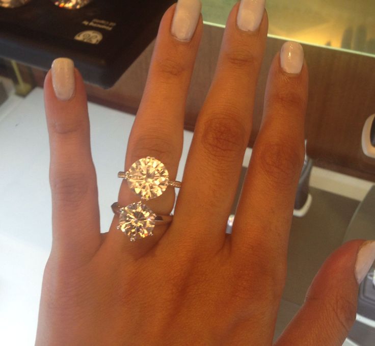 a close up of a person's hand with a ring on it and a diamond in the middle