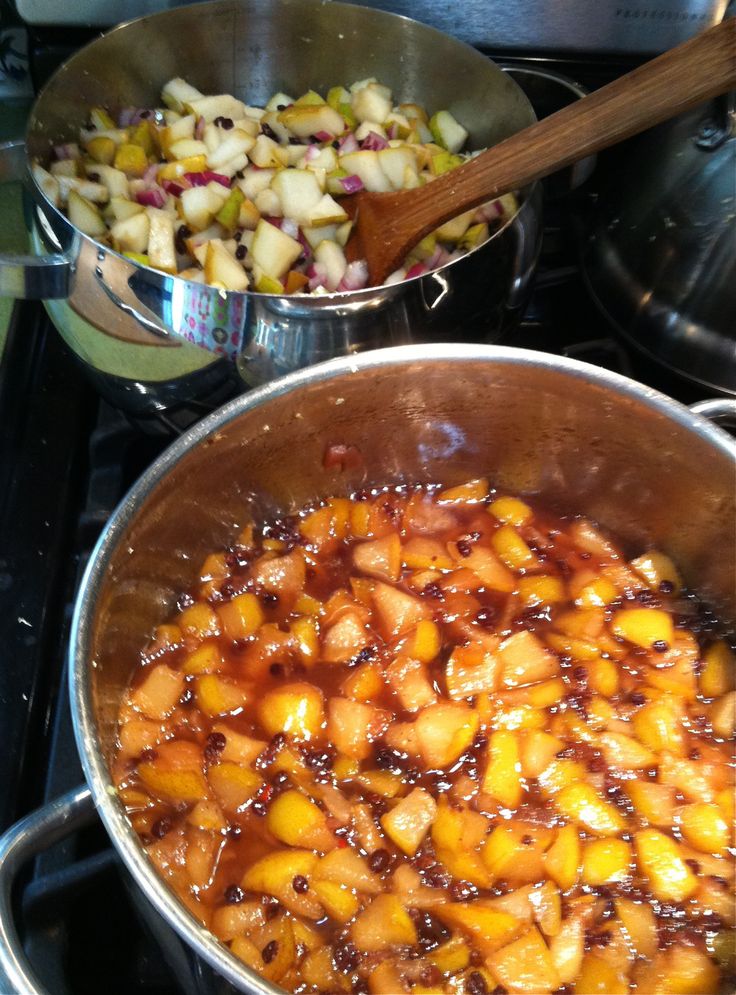 two pans filled with food sitting on top of a stove next to each other