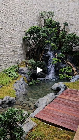 a small waterfall in the middle of a garden