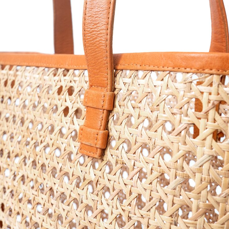 The Ideal basket tote bag. Handcrafted using our cane rattan with premium genuine leather. The perfect light, easy to pack for your travel adventures carry all beach day, market run, summer lunch date shoulder tote bag. (PRODUCT INFO): Material: Genuine Cow leather + Cane RattanLining: Unlined interiorSize: 14" W x 11" H x 4.3" DOpen top no closure (SHIPPING INFO): All our items are made-to-order, therefore please allow 3-5 business days for production. Our goal is to become more sustainable thr Light Brown Summer Beach Bag For Everyday Use, Summer Style Light Brown Beach Bag For Everyday Use, Light Brown Bucket Bag For Daily Use In Summer, Summer Light Brown Bucket Bag For Daily Use, Summer Everyday Light Brown Beach Bag, Brown Rattan Tote Beach Bag, Leather Bucket Bag With Bamboo Handle In Natural Color, Natural Leather Bucket Bag With Bamboo Handle, Light Brown Tote Beach Bag For Summer